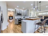 Modern kitchen with stainless steel appliances, a breakfast bar, and an open layout at 2339 Whistler Dr, Longmont, CO 80504