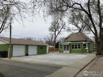 Quaint green house with a detached two car garage and ample parking space at 303 17Th Ave, Longmont, CO 80501