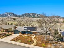 Stunning home featuring solar panels, professional landscaping, and breathtaking mountain views at 385 Erie Dr, Boulder, CO 80303