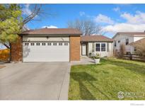 Charming single-story home featuring a brick and siding exterior with an attached two-car garage at 434 7Th St, Mead, CO 80542