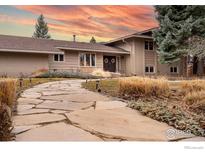 Charming home featuring a stone walkway leading to a welcoming front door with decorative wreaths at 6914 Frying Pan Rd, Boulder, CO 80301