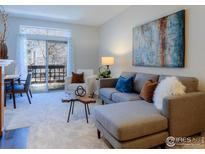 Cozy living room with modern furnishings, large window, and a comfortable seating area with stylish decor at 7419 Singing Hills Ct, Boulder, CO 80301