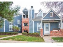 Charming blue two-story condo with well-maintained lawn and inviting front porch at 11197 Alcott St # C, Denver, CO 80234