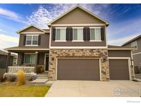 Charming two-story home with stone accents and a three-car garage at 1401 Vantage Pkwy, Berthoud, CO 80513