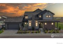Charming two-story home with a beautifully landscaped yard and inviting stone accents at 1563 Stoneseed St, Berthoud, CO 80513