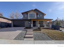 Striking two-story home with stone accents, a covered porch, and a well-maintained front yard at 2700 15Th St, Boulder, CO 80304
