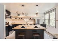 Modern kitchen features stainless appliances, butcher block island, open shelving and pendant lighting at 3035 Oneal Pkwy # V-11, Boulder, CO 80301