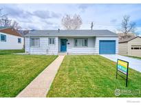 Charming single-story home with a well-maintained lawn and inviting curb appeal, ready for new owners at 325 27Th St, Boulder, CO 80305
