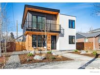Modern two-story home boasts a mixed material facade, balcony, and landscaped front yard at 4455 Xavier St, Denver, CO 80212