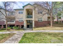 Attractive condo exterior with brick accents, a quaint balcony, and well-maintained landscaping at 550 Mohawk Dr # 67, Boulder, CO 80303
