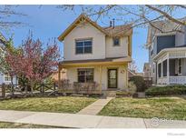 Charming two-story home with inviting front porch, well-manicured lawn and beautiful curb appeal at 596 Mills St, Lafayette, CO 80026