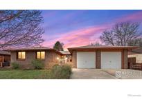 Charming brick home with a two-car garage and well-maintained landscaping at 1501 Willow Dr, Berthoud, CO 80513