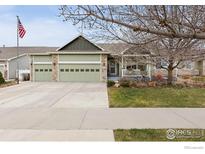 Charming single-story home with a three-car garage, covered porch, and well-maintained lawn at 2518 Palmer Ave, Mead, CO 80542