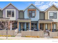 Colorful townhomes with private patios featuring wood fences and sleek black metal gates at 5318 5Th St # E, Boulder, CO 80304