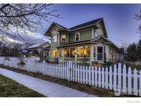 Charming two-story home with a white picket fence and inviting curb appeal at 705 7Th St, Berthoud, CO 80513
