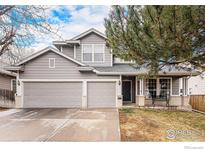 Charming two-story home with a three-car garage and inviting front porch at 13421 Humboldt Way, Thornton, CO 80241