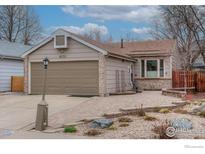 Charming single-story home with a well-maintained front yard and attached two-car garage at 1630 Calkins Ave, Longmont, CO 80501