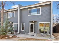 Inviting two-story townhouse with a gray exterior, a cozy front patio, and a well-maintained landscape at 1709 Alpine Ave # 6, Boulder, CO 80304