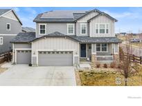 Charming two-story home with a covered porch, solar panels, three-car garage, and well-maintained landscaping at 4621 Prairie River Ct, Longmont, CO 80504