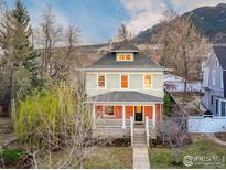 Charming two-story home with a brick porch, landscaped yard, and mountain views at 720 Mapleton Ave, Boulder, CO 80304