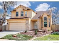 Charming two-story home with a two-car garage, beautiful landscaping, and blue skies at 1080 Stoneham St, Superior, CO 80027