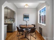 Bright dining area featuring hardwood floors and a window view at 1130 N Pennsylvania St # 306, Denver, CO 80203