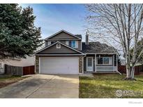 Charming two-story home featuring a two-car garage and covered front porch at 1219 Cedarwood Dr, Longmont, CO 80504