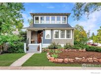 Charming two-story home featuring landscaped front yard and inviting front porch at 1741 Pine St, Boulder, CO 80302