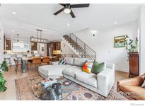 Open-concept living room with modern furnishings, hardwood floors, and staircase to the second floor at 2471 Walnut St, Boulder, CO 80302