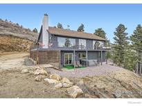 Stunning exterior view of a gray two-story home, featuring a large deck and scenic mountain views at 274 Boulder View Rd, Boulder, CO 80302