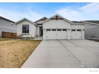 Charming single-Gathering home featuring a spacious three-car garage and modern farmhouse design at 334 Rhubarb Dr, Berthoud, CO 80513