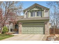 Charming two-story home with a well-manicured lawn and a large two car garage at 3469 Larkspur Dr, Longmont, CO 80503