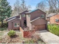 Two story home boasts solar panels, attached garage, and landscaping at 3885 Birchwood Dr, Boulder, CO 80304