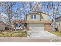 Charming two-story home with an attached two-car garage, well-maintained lawn, and mature trees at 4275 Corriente Pl, Boulder, CO 80301