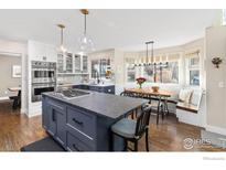 Well-appointed kitchen with a large island, stainless steel appliances, and an adjacent dining area at 501 W Linden St, Louisville, CO 80027