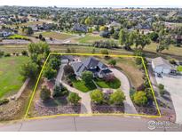 Expansive aerial view of home featuring lush landscaping, circular driveway, and proximity to open spaces and neighborhood amenities at 5700 Eagle Shadow Ave, Brighton, CO 80602