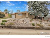 Charming brick home with a well-maintained front yard and mature tree offering shade at 615 S Shoshone St, Denver, CO 80223