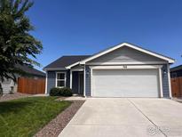 Charming single-Gathering home featuring a two-car garage and well-maintained landscaping at 702 S Fulton Ave, Fort Lupton, CO 80621
