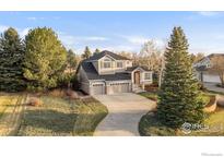 Charming two-story home with a three car garage and a curved driveway at 8542 Waterford Way, Niwot, CO 80503