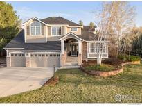 Charming two-story home featuring a three-car garage and beautifully landscaped front yard at 8542 Waterford Way, Niwot, CO 80503