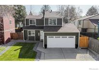 Charming two-story home features a two-car garage, nice yard, and mature trees at 1210 Baker St, Longmont, CO 80501