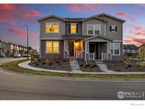 Charming two-story home featuring a well-maintained lawn, inviting entrance, and modern architectural details at 1365 Shale Dr, Erie, CO 80516
