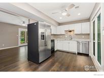Bright kitchen with stainless steel appliances and white cabinets at 1607 Cottonwood Dr # 14, Louisville, CO 80027