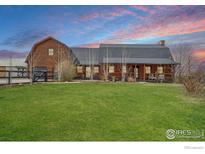 Charming log home with a well-manicured lawn and beautiful landscaping, perfect for outdoor enjoyment at 2587 Horseshoe Cir, Longmont, CO 80504