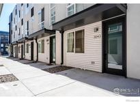 Modern townhome exterior features black accents, light siding, and well-maintained walkways at 3043 W 19Th Ave, Denver, CO 80204