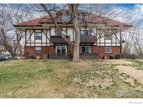 Exterior shot showcasing balconies and lush greenery with a backdrop of mature trees and a well-manicured lawn at 3250 Oneal Cir # H17, Boulder, CO 80301