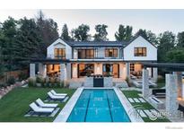 Stunning backyard view showcasing pool, patio, and elegant home exterior with stone accents and lush landscaping at 706 Juniper Ave, Boulder, CO 80304