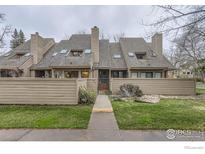 Charming townhome with a well-manicured lawn, wooden fence, and inviting front entrance at 747 Meadow Glen Dr, Boulder, CO 80303
