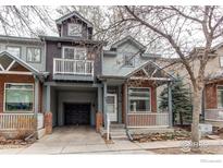 Charming two-story home with a front porch, balcony, garage, and a blend of brick and siding at 828 Kane Dr # 35, Longmont, CO 80501