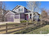 Charming two-story home with a well-maintained yard and a cozy front porch at 85 Kolar Ct, Erie, CO 80516